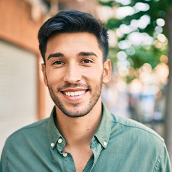 Closeup of man smiling while walking outside