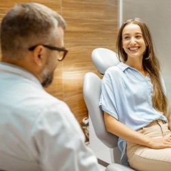 Female patient smiling at dentist at dental appointment