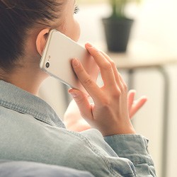 Closeup of woman talking on phone at home