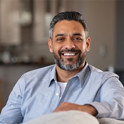 Man sitting on a couch and smiling