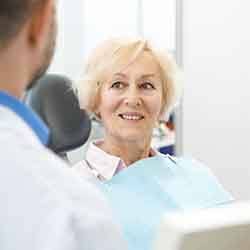 patient smiling while talking to dentist 